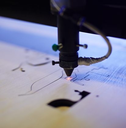 Laser beam cutting plywood sheet